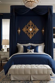 a bed with blue sheets and pillows in a bedroom next to a chandelier