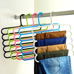 a rack with clothes hanging on it and the words home & garden essentials above it