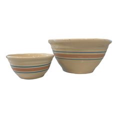 two bowls sitting next to each other on a white surface