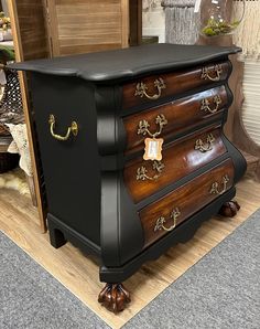 an antique chest of drawers is on display in a store with other furniture and accessories