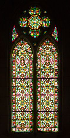 a large stained glass window in a church