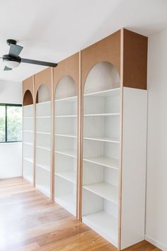 the empty room is clean and ready to be used as a storage area for books