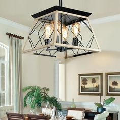 a dining room table with chairs and a light fixture hanging over it's head