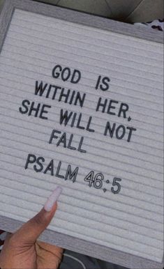 someone holding up a sign that says god is within her she will not fall