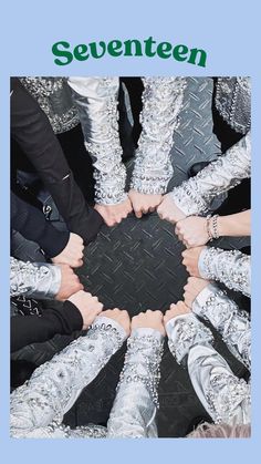 several people are standing in a circle with their hands together