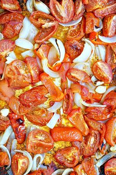 tomatoes and onions are being cooked in a skillet