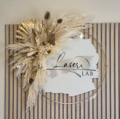 a piece of paper that has been placed on top of a table with some dried plants