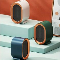 three different colored speakers sitting on top of blue and white boxes next to each other