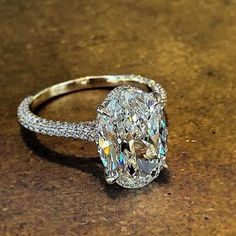 an oval cut diamond ring on a table