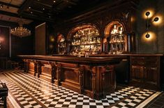 an old fashioned bar with black and white checkered flooring