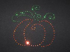 a lighted pumpkin is shown in the middle of the night with lights on it's face