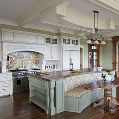 a large kitchen with an island in the middle and lots of cabinets on both sides