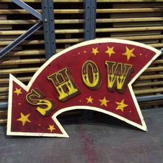 a wooden sign that says wow and has yellow stars on it in the shape of an arrow