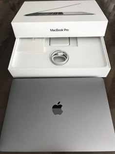 an apple macbook pro with its box opened