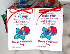 two valentine's day cards with candy in the background