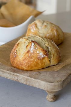 two pastries sitting on top of a wooden board