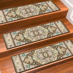 three rugs on the steps leading up to a door