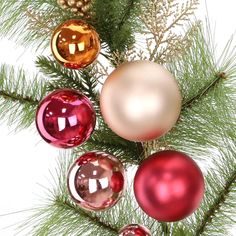 an arrangement of christmas ornaments hanging from a pine tree