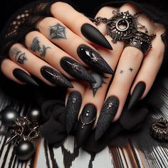 Discover the magic of matte with these Gothic black nail designs. Perfect for every occasion, these nails feature a deep matte black finish with intricate Gothic elements. Add a touch of mystery and style to your look with these chic and sophisticated nails. Dark Christmas Nails Almond, Gothic Romance Nails, Christmas Goth Nails, Vampire Nails Gothic, Goth Winter Nails, Black Gothic Nails, Gothic Christmas Nails, Witchy Nail Designs, Black Nails Matte