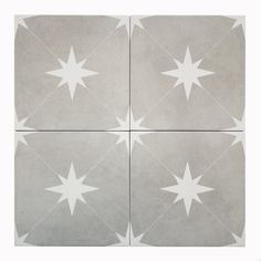 four square tiles with white stars on them in different sizes and shapes, all arranged together