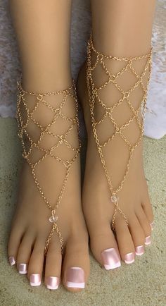 This lovely pair of barefoot sandals features dainty gold linked metal chain that accents the ankle and top of the foot. The toe section is dotted with a clear accent bead and each piece detaches at the back of the ankle with a lobster claw latch. They are size adjustable and one size fits most. Comfortable and versatile, they will lend themselves to casual or formal events. My barefoot sandals are sold as a pair and are one size fits most All items are made in a smoke free environment * If ther Bohemian Barefoot Sandals, Beach Barefoot Sandals, Gold Barefoot Sandals, Anklets Summer, Foot Jewelry Wedding, Silkroad Online, Lace Barefoot Sandals, Barefoot Sandals Wedding, Bride Heels