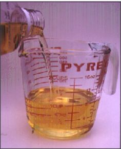 a measuring cup filled with liquid being poured into it