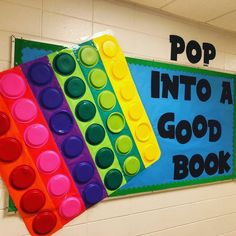 a bulletin board that says pop into a good book