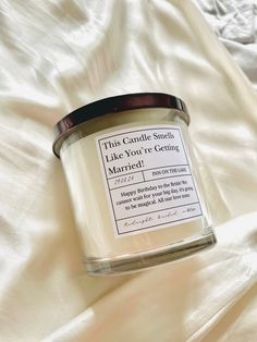 this candle smells like you're getting married in a jar on a white sheet