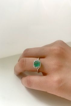 14k Gold, Micro Pave, Diamond Halo, Colombian Emerald ring. This fine statement ring would make a perfect gift for any occasion it can also be used as a stunning engagement ring. The Diamond halo along with the claw setting gives this ring it a chic yet classic look so that you turn heads where ever you go. Center stone: Colombian Emerald Centerstone weight: 1.20 ct Diamond halo: .15G color white diamond, VS clarity. Ring Size: Adjustable Made in: New York City Made to order If required, please Colombian Emerald Engagement Ring, Emerald Ring Designs For Women, Emerald Ring Design, Diamond Emerald Ring, Emerald Stone Rings, Colombian Emerald Ring, Anklet Tattoos, Claw Setting, Stunning Engagement Ring