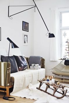 a living room filled with furniture and pictures on the wall