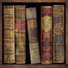 old books are lined up in a wooden box on the shelf, and one is empty