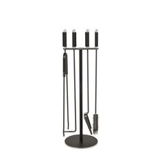 a set of four black candles on a stand with one candle in the middle and two sticks sticking out of it