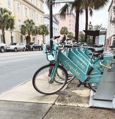 there are many bikes parked on the side of the street