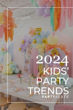 a party with balloons and streamers for kids's birthdays in pastel colors