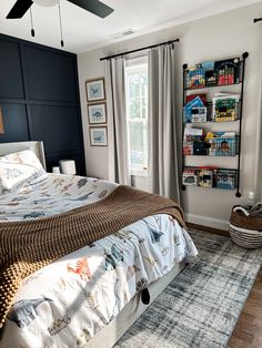 a bedroom with a bed, ceiling fan and bookshelf in the corner on the wall