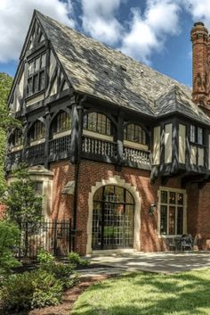 an old brick house with black and white trim