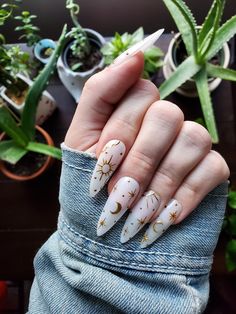 These nails feature a milky white base with a gold chrome celestial pattern. Each nail set includes 10 hand painted, press on nails and a nail prep kit (tube of nail glue, cuticle pusher, nail file/buffer). Lauren is wearing 'long almond' in size Medium. For help with sizing, please use our sizing guide. Ongles Beiges, Witchy Nails, Moon Nails, Acrylic Press On Nails, Gold Chrome, Chic Nails, Gold Nails, Cute Acrylic Nails, Wedding Nails