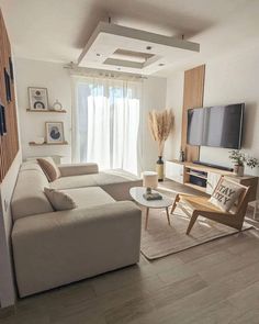 a living room filled with furniture and a flat screen tv on top of a wall