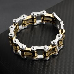 Description: Stainless steel black and 18K gold plated bike chain bracelet. Approx. Weight: 67 grams Available Sizes: 7", 8", 9" Approx. Dimensions(mm): 18mm x 177.8mm (Length varies by SKU) Approx. Dimensions(Inches): 0.71" x 7" (Length varies by SKU) Bike Chain Bracelet, Biker Chain, Bike Chain, Stainless Steel Polish, Jewelry Website, Stylish Bracelet, Stay Active, Chain Design, Stainless Steel Rings