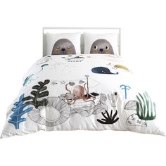 a bed with an animal themed comforter and two pillows