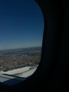 the view from an airplane window looking down on a city