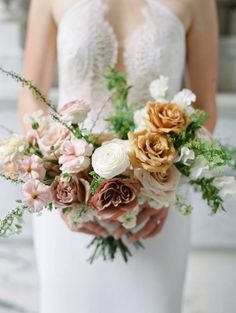 a bride holding a bouquet of flowers in her hands