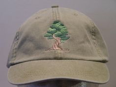 NEW EMBROIDERED BONSAI ORNAMENTAL INDOOR TREE WILDLIFE HAT (HATS PICTURED ARE KHAKI, BLACK, BURGUNDY, FOREST GREEN, WHITE AND OLIVE GREEN) Adams Optimum 6 Panel Baseball Hat Low Profile - 100% Cotton Twill Adult Cap Pigment Dyed - Garment Washed Hat 6 Panels with Sewn Matching Eyelet Visor with 3 Rows of Stitching Pre-formed Bill - Leather Strap with Brass Grommet Adjustable - One Size Fits Most An Extremely Comfortable Baseball Hat! Enjoy the Embroidered Bonsai Japanese Ornamental Tree Wildlife Hat! We have 24 Different Solid Color Baseball Hats Available Please Choose the Color You Prefer! Thanks for Shopping at Price Embroidery & Apparel! Embroidery Apparel, Tree Hat, Swag Hats, Indoor Tree, How To Wash Hats, Indoor Trees, Flex Fit Hats, Green Cap, Soft Boy