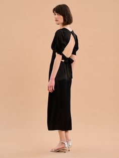 Odette is elegance with an edge. The 3/4 length sleeves are gathered at the bottom to create a feminine silhouette offset with a deep v-neckline. With an open back with sash detail, this dress in timeless black is a date night dream. Crafted from LENZING™ ECOVERO™ viscose it will eventually biodegrade, although we’re pretty sure you’ll never want to let this baby go. Odette Dress, Twist Front Dress, V Dress, Swimwear Shorts, Feminine Silhouette, Twist Front, Shirt Skirt, Denim Top, Holiday Dresses