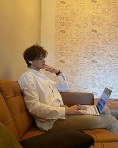 a person sitting on a couch with a laptop