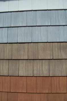 several different colored shingles on the side of a building