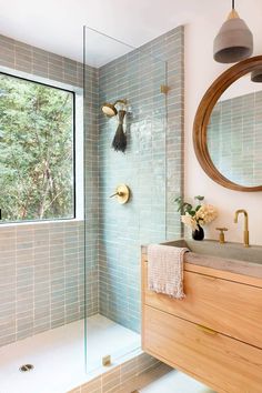 a bathroom with a sink, mirror and shower