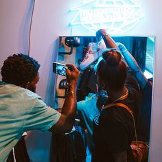 a man taking a photo of himself in front of a mirror with his cell phone