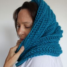 a woman wearing a blue knitted scarf