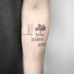 a family tree tattoo on the left forearm and arm, with an inscription below it